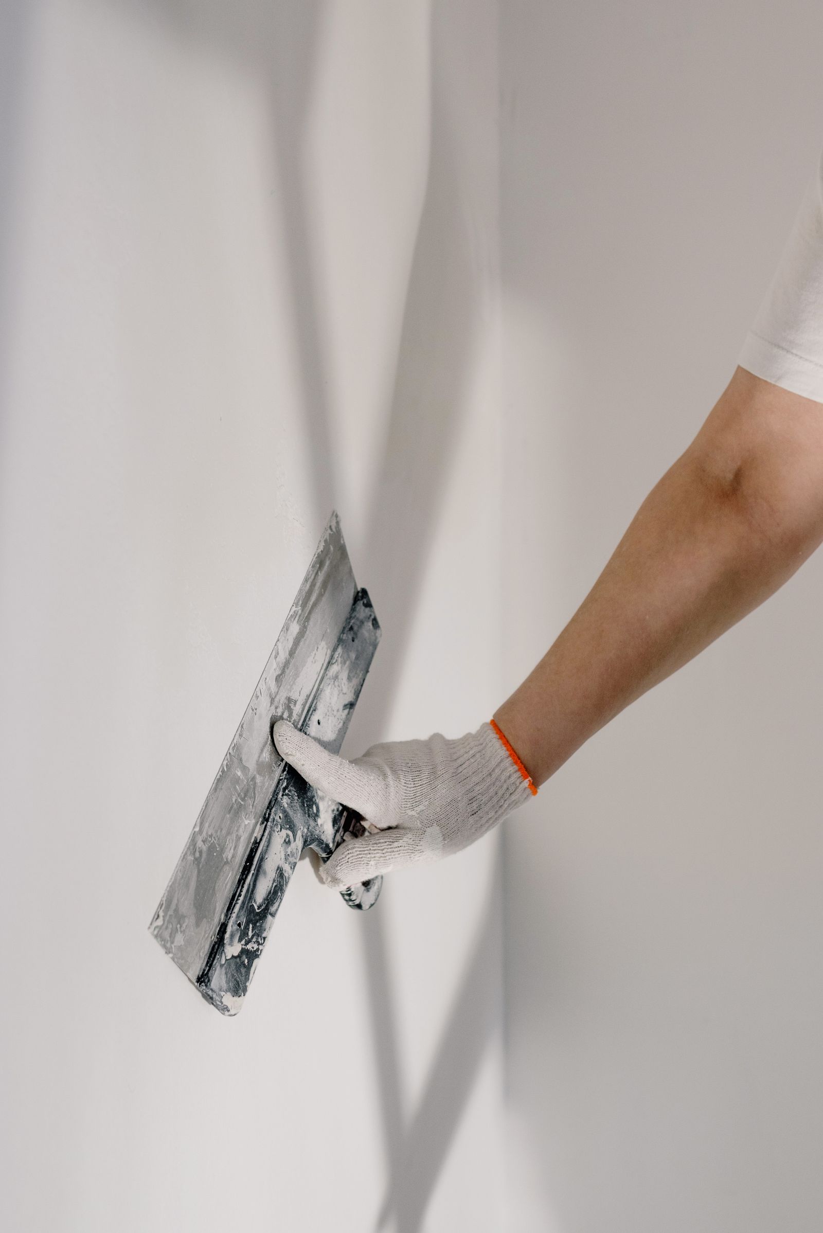 Hand smoothing a patched wall